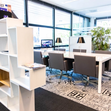 Furnished office space with a meeting table and chairs at Kampenringweg 45, Gouda, ideal for office space rental.