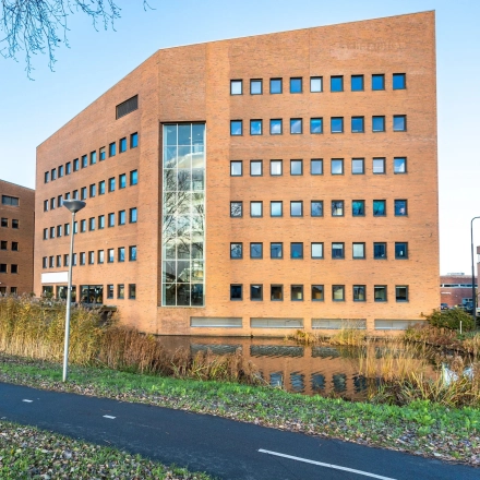 Exterior view of a brick office building at Zuidelijk Halfrond 1, Gouda, ideal for those seeking office space rental.