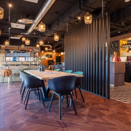 Modern furnished office space in Gouda with a stylish open floor plan featuring wooden floors and contemporary lighting. Ideal for office space rental.