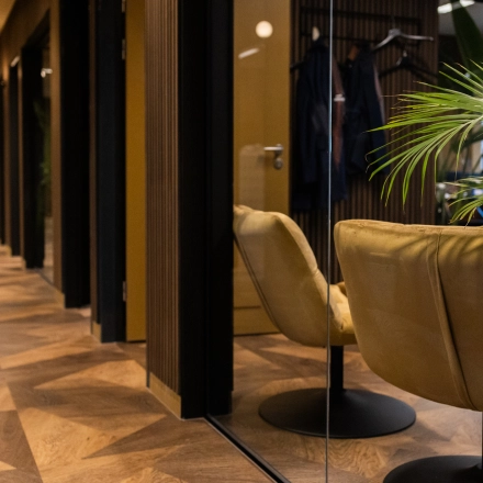 Modern office space to rent at Zuidelijk Halfrond 1, Gouda, showing a hallway with stylish chairs and potted plants, ideal for office space rental.