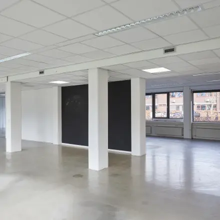 Spacious and unfurnished office space available for rent at Schweitzerlaan 12, Groningen. Features open floor plan with ample natural light, ideal for custom office space rental setup.