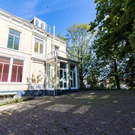 Exterior view of an office available for rent at Prinsen Bolwerk 1, Haarlem Centraal Station, with a charming building and a spacious surrounding area.