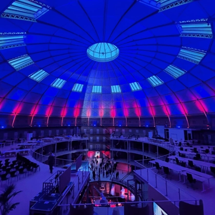 Spacious office space rental in Haarlem Centrum with a stunning dome ceiling and ambient lighting, perfect for an open floorplan setup.