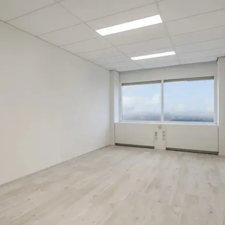 Bright unfurnished office space available for rent at A. Hofmanweg 5A in Haarlem Waarderpolder, featuring wide windows and modern lighting.