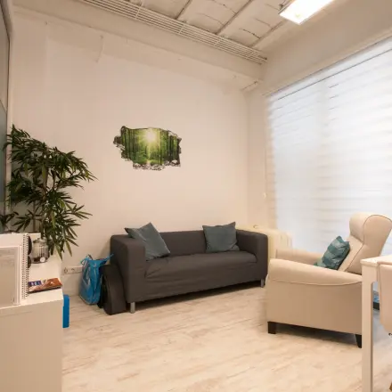 Bright office space rental at Waarderweg 19, Haarlem Waarderpolder, featuring a cozy seating area with a sofa and armchair. Ideal for those looking to rent office space with natural light.