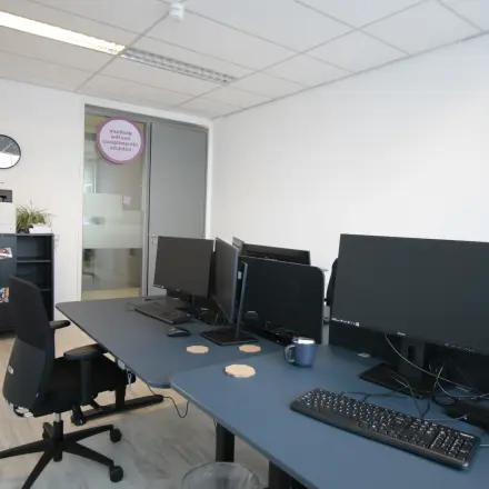 Spacious office space available for rent in Haarlem Waarderpolder, featuring multiple desks with computers and ergonomic chairs. Perfect for those seeking office space rental.