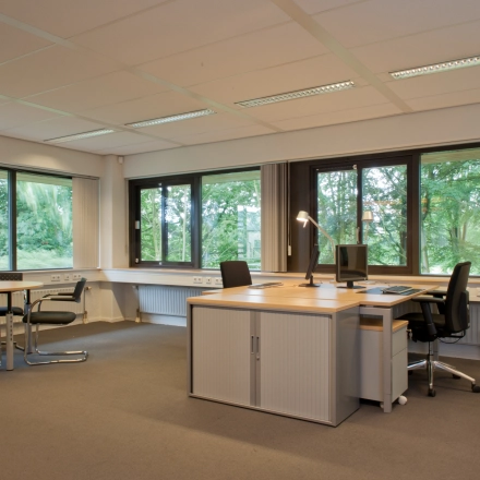 Furnished office space at Herenweg 115, Heemstede with desks and chairs near large windows, ideal for rent office space.