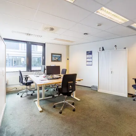 Furnished office space at Welbergweg 60 in Hengelo, featuring desks and chairs, ideal for rent office space needs.