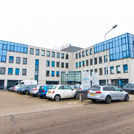 Exterior view of an office building at Franciscusweg 219, Hilversum, ideal for rent office space with ample parking.