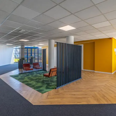 Spacious office to rent at Franciscusweg 219 in Hilversum, featuring a modern layout with semi-private workspaces and bright colors.