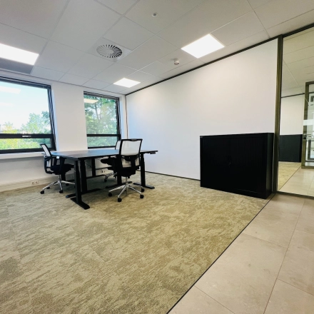 A bright office to rent at Marathon 2, Hilversum, featuring desks, chairs, and ample natural light. Ideal for office space rental needs.