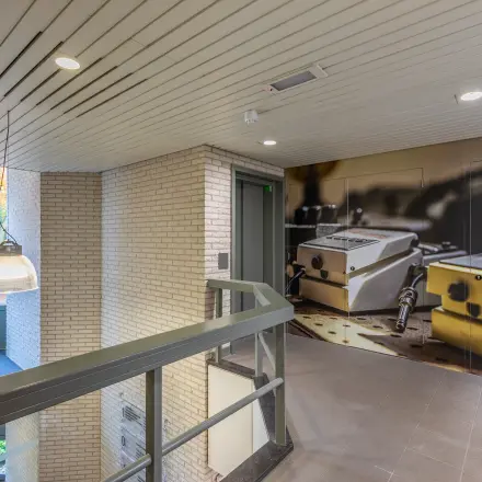 Bright office entrance at Mozartlaan 27, Hilversum, ideal for office space rental, with urban artwork on the wall.