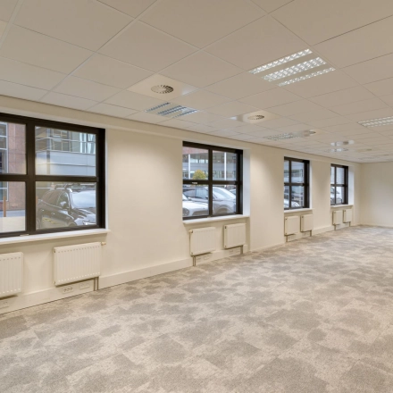 Bright and spacious office to rent at Olympia 1, Hilversum, featuring large windows and a modern carpet, ideal for your office space rental needs.