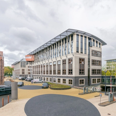 Exterior view of Olympia 1 in Hilversum, showcasing a modern office building available for rent.