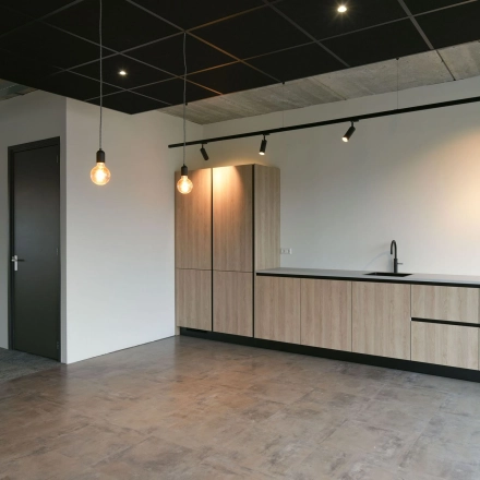 Modern office space with sleek lighting and minimalistic design available for rent at Zuiderloswal 55, Hilversum.