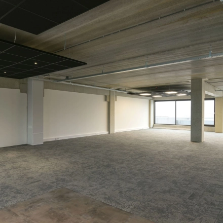 Spacious office area at Zuiderloswal 55, Hilversum, available for rent with large windows allowing natural light, ideal for office space rental.