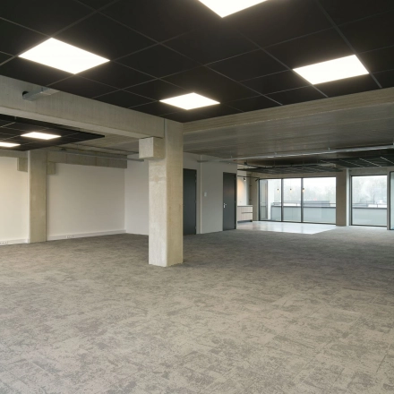 Spacious office to rent at Zuiderloswal 55, Hilversum, featuring large windows and modern lighting, ideal for office space rental.