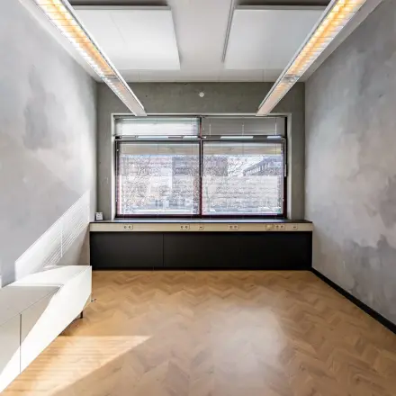 Unfurnished office space rental at Opaallaan 1180, Hoofddorp, featuring large windows and wooden flooring, ideal for a fresh start.