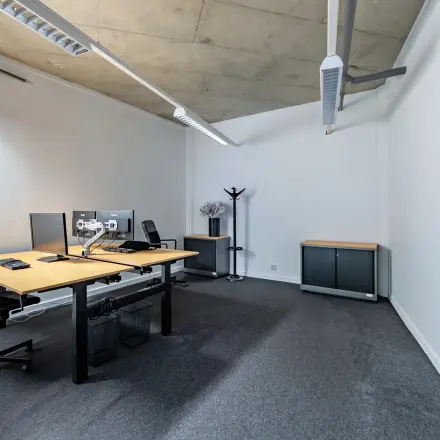 Furnished office space for rent at Opaallaan 1180, Hoofddorp, featuring modern desks, chairs, and computers in a well-lit interior.