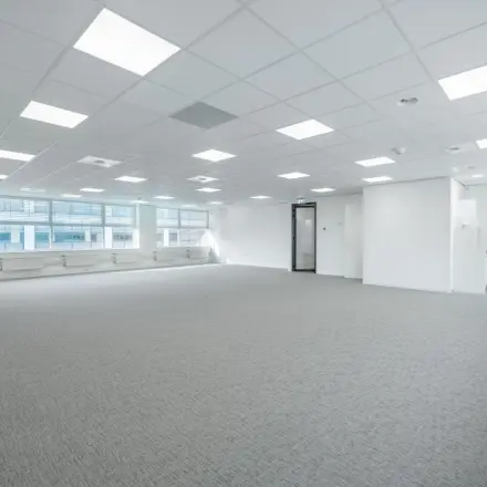 Spacious office space rental at Polarisavenue 130-150, Hoofddorp, featuring large windows and a modern ceiling design.