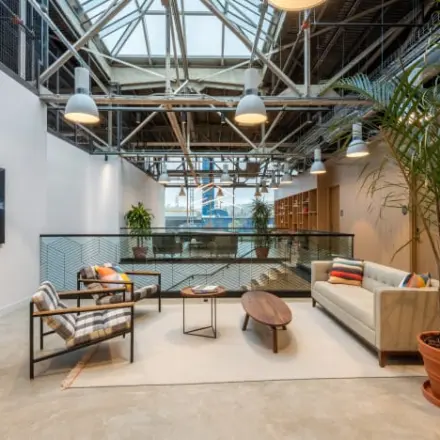 Modern office lounge with stylish furniture, plants, and natural light at Siriusdreef 17, ideal for office space rental in Hoofddorp.