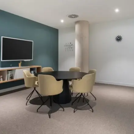 Modern office space for rent at Siriusdreef 17, Hoofddorp, featuring a sleek meeting area with a round table and minimalist decor.