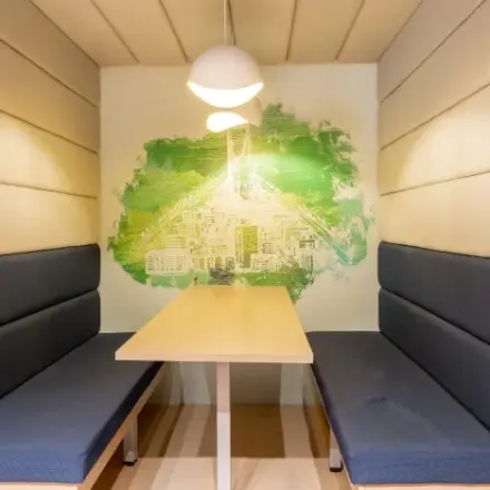Cozy furnished workspace at Siriusdreef 17 in Hoofddorp available for rent office space with seating booths and unique wall design.
