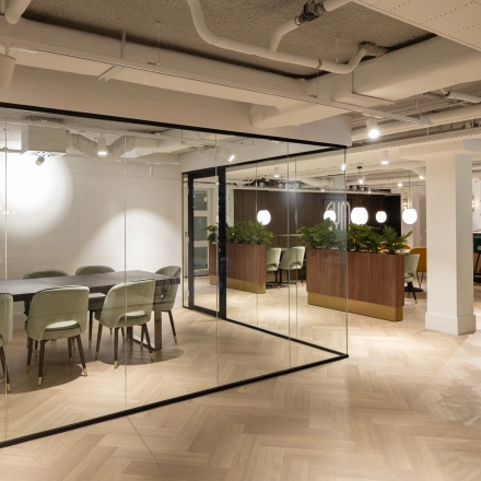 Modern office space with glass-walled conference room and stylish wooden dividers, offering a versatile workspace in Siriusdreef 60, Hoofddorp. Ideal for businesses looking for an office space rental with an elegant touch.