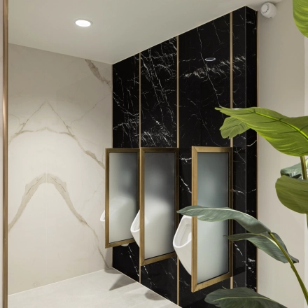 Modern restroom with elegant black marble partitions and green plant accents, located at Siriusdreef 60 in Hoofddorp, available for office space rental.