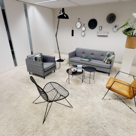 Stylish office space rental in Houten featuring cozy seating, modern decor, and a welcome area ideal for meetings or relaxation.