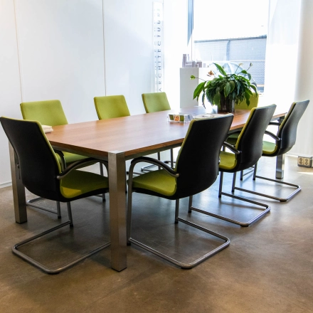 Bright office space with a modern table and green chairs, ideal for office space rental at Brieltjenspolder 28, Made.