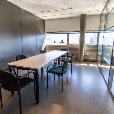Bright, furnished office space rental in Made at Brieltjenspolder 28, featuring a meeting table and chairs with ample natural light.