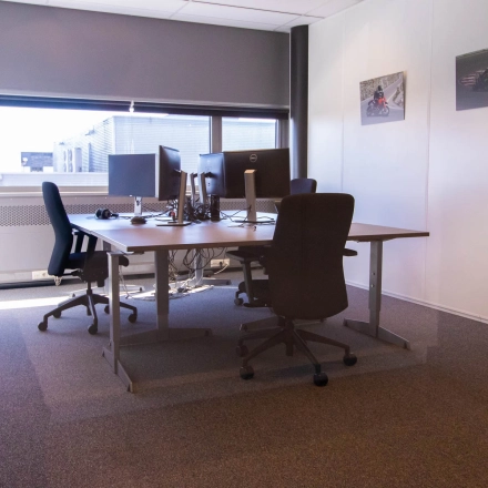 Bright office space with desks and chairs, available for rent at Brieltjenspolder 28, in Made. Ideal for office space rental needs with a cozy setup.