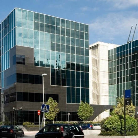 Contemporary glass-fronted office building located on Avenida del Partenón 16-18, offering sleek office space rental in Madrid Barajas.
