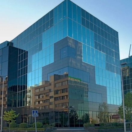 Modern glass office building located at Avenida del Partenón 16-18, Madrid Barajas, available for rent as office space.
