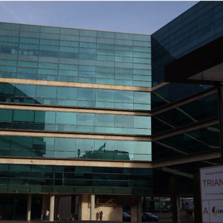 Glass-facade building located at Calle Vía de los Poblados 1 in Madrid Hortaleza, ideal for office space rental. Exterior view showcasing modern architecture suitable for businesses looking to rent office space.