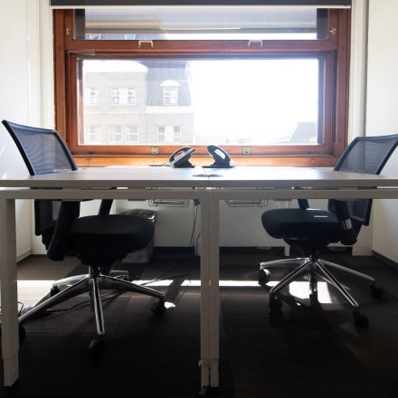 Bright office to rent at Paseo de Recoletos 5, Madrid Recoletos, featuring two chairs and a desk under a large window.