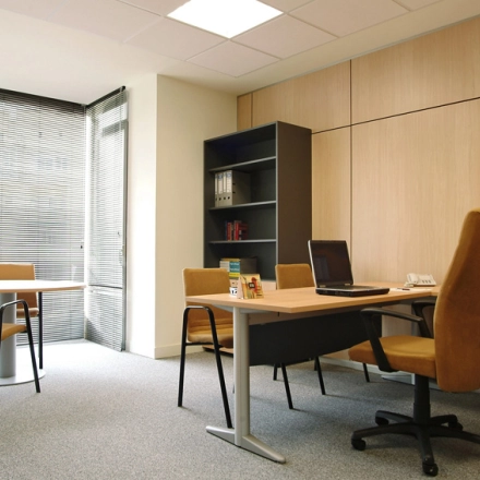Bright office space on Avenida de Brasil 6, Madrid Tetuán, featuring desks, chairs, and shelves for rental use.