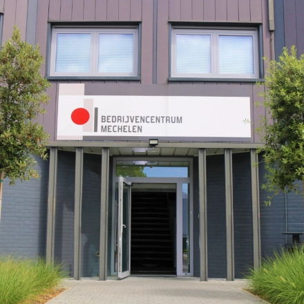 Exterior view of office space available to rent at De Regenboog 11, Mechelen North, featuring a modern facade with large windows.