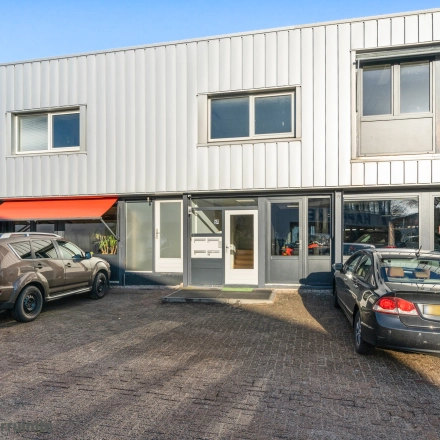 Exterior view of office building at Nijverheidsweg 9B, Nieuwegein, showcasing parking for potential office space rental.