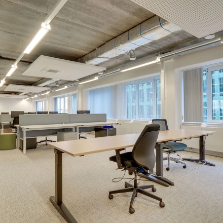 Spacious office interior at Zoomstede 19, Nieuwegein with modern furnishings and large windows. Ideal for those seeking office space rental. Features adjustable desks and ergonomic chairs in an open floor plan.