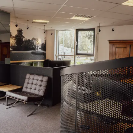 Office space with modern furniture and a spiral staircase, suitable for rental at Abdis van Thornstraat 74, Oosterhout Nb.