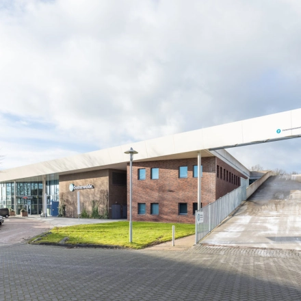 Exterior view of an office building located at Veengang 1, Oosterwolde, ideal for office space rental.