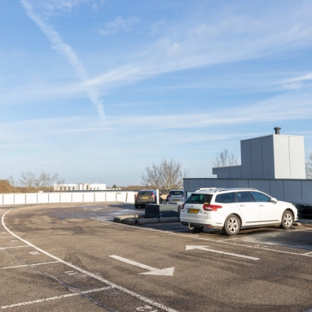 Parking area at Veengang 1, Oosterwolde, offering convenient access to rent office space in the building.