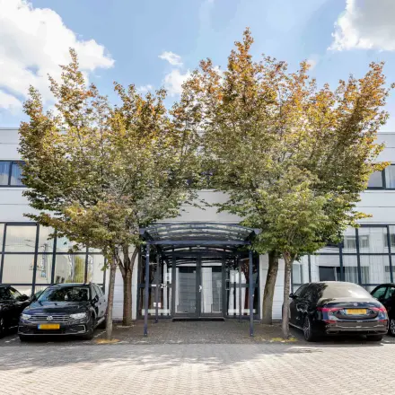 Exterior view of the office at Leeghwaterstraat 25, Reeuwijk, featuring a modern facade and parking area.