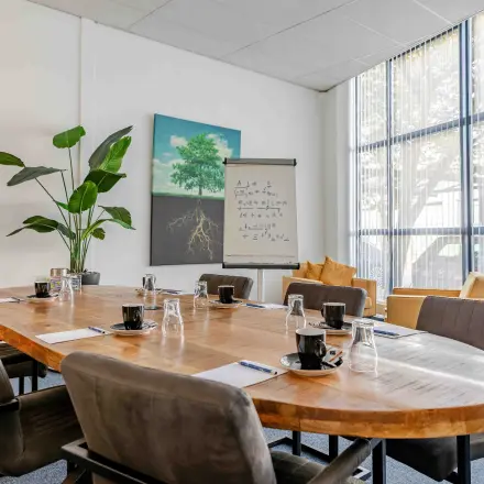Well-lit conference room at Leeghwaterstraat 25, Reeuwijk, featuring a large table and chairs, suitable for office space rental.