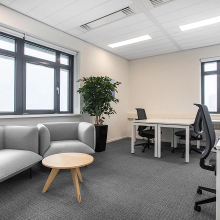 Modern office space rental at Einsteinlaan 28, Rijswijk, featuring a bright, furnished interior with seating and workstations.