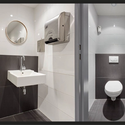 Rijswijk office space rental at Patrijsweg 62, featuring a modern restroom with sleek fixtures and tiled surfaces.