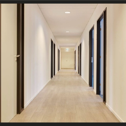 Office hallway at Patrijsweg 62, Rijswijk, featuring a series of doors leading to various office spaces. Ideal for office space rental.
