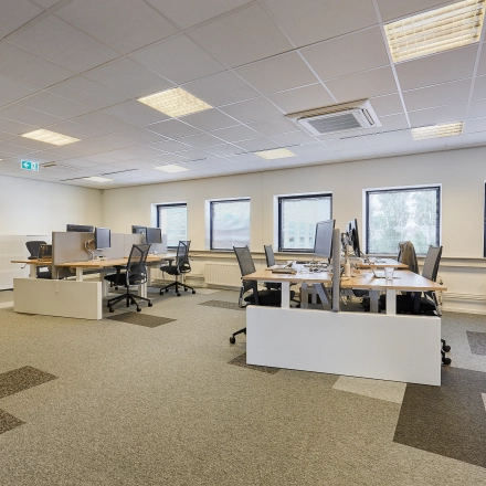 Office space at Patrijsweg 62, Rijswijk, featuring rows of desks and chairs under a grid ceiling, ideal for office space rental.